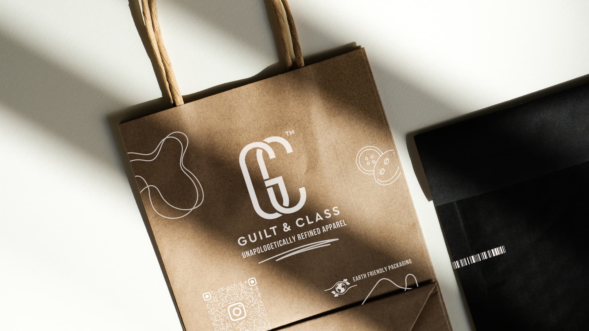 Brown paper bag with 'Guilt & Class' branding on a white background