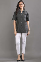 Angled view of the Ash in Form denim shirt by Guilt & Class, highlighting the relaxed fit and soft washed finish.