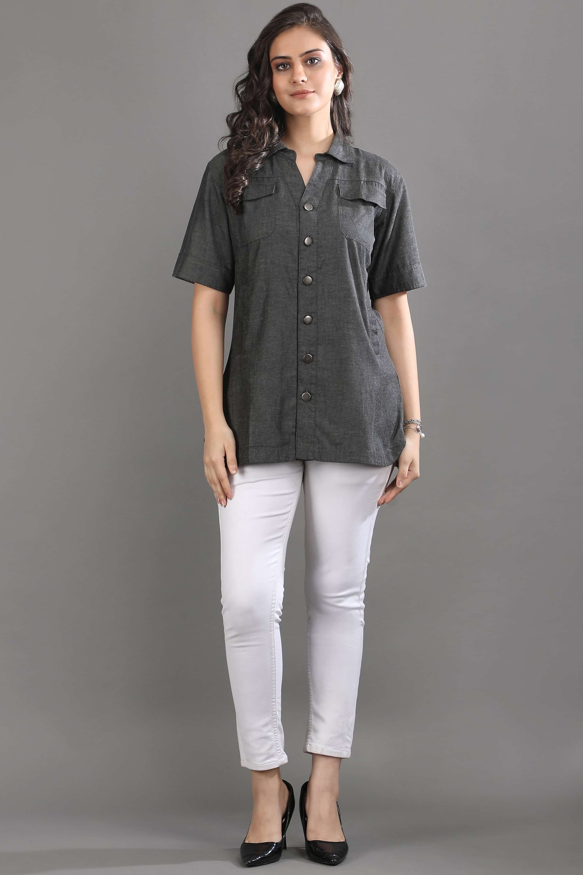 Angled view of the Ash in Form denim shirt by Guilt & Class, highlighting the relaxed fit and soft washed finish.