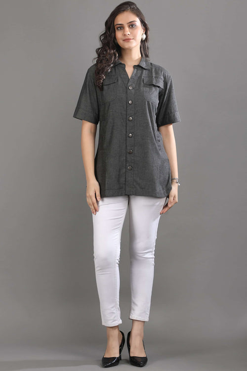 Angled view of the Ash in Form denim shirt by Guilt & Class, highlighting the relaxed fit and soft washed finish.