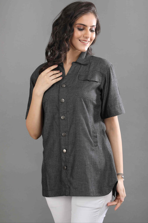 A model wearing the Ash in Form denim shirt by Guilt & Class, featuring a lightweight cotton denim fabric with a washed grey-black finish.