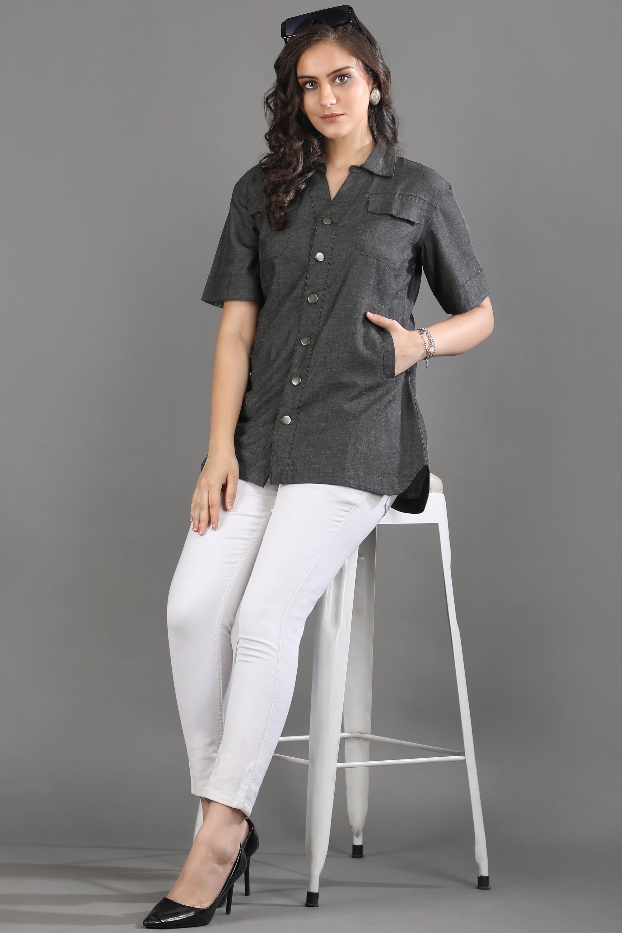 A model in motion wearing the Ash in Form denim shirt by Guilt & Class, highlighting its breathable lightweight denim and relaxed fit.