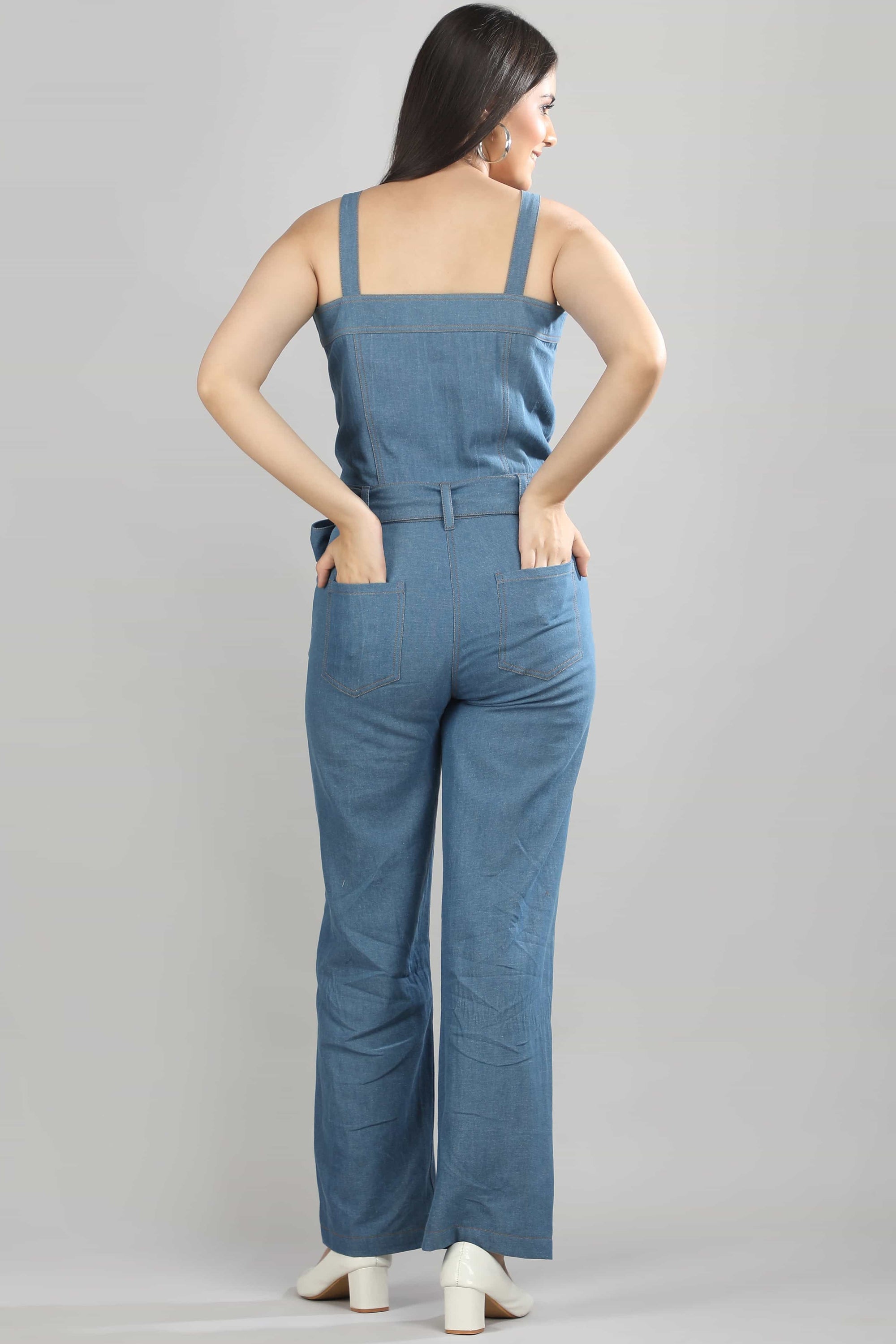 Back view of the Caught in Denim jumpsuit by Guilt & Class, showing the clean silhouette and structured denim finish.
