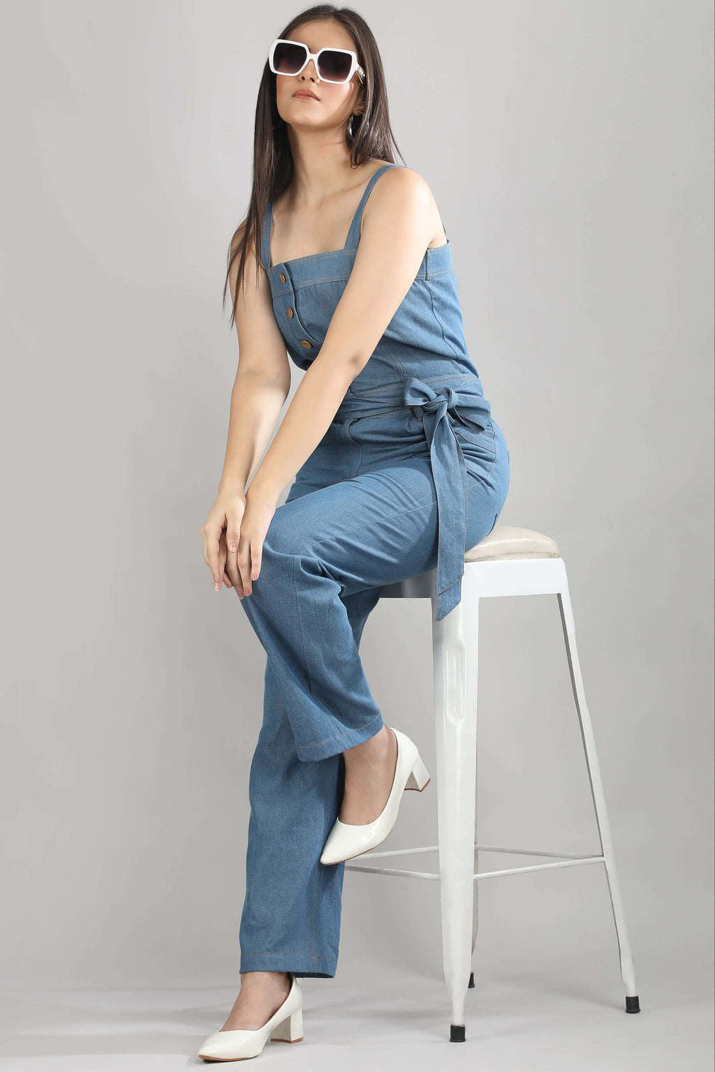 [blue] Styled view of the Caught in Denim jumpsuit by Guilt & Class, designed for effortless day-to-evening wear.
