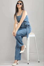 [blue] Styled view of the Caught in Denim jumpsuit by Guilt & Class, designed for effortless day-to-evening wear.