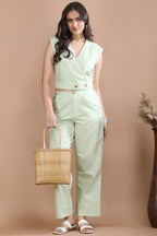 Model styling the Celadon Story co-ord set by Guilt & Class with a woven basket bag, featuring a breathable cotton-linen silhouette and coconut button detailing