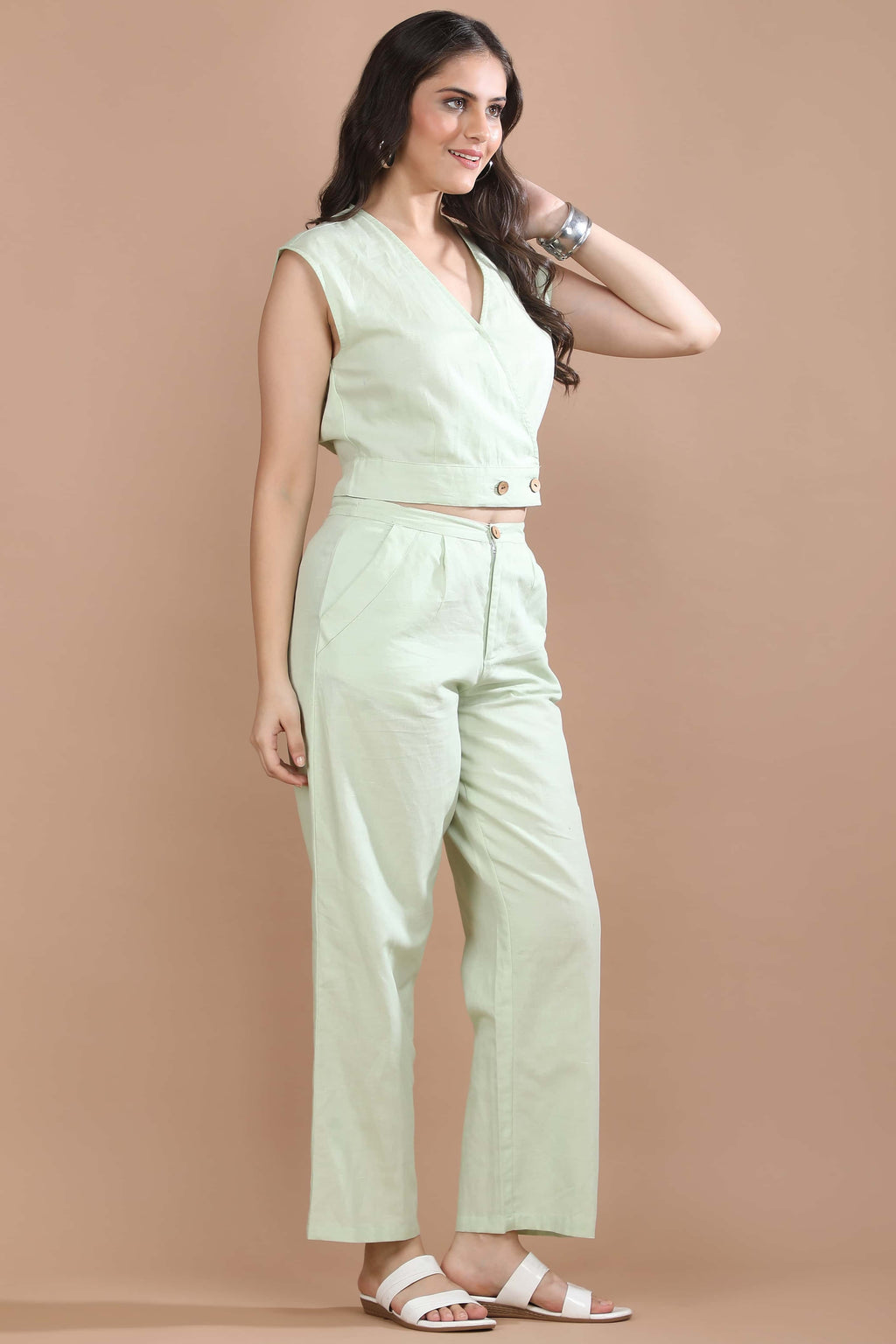 Three-quarter view of the Celadon Story co-ord set by Guilt & Class highlighting the wrap-style top and clean tailored silhouette