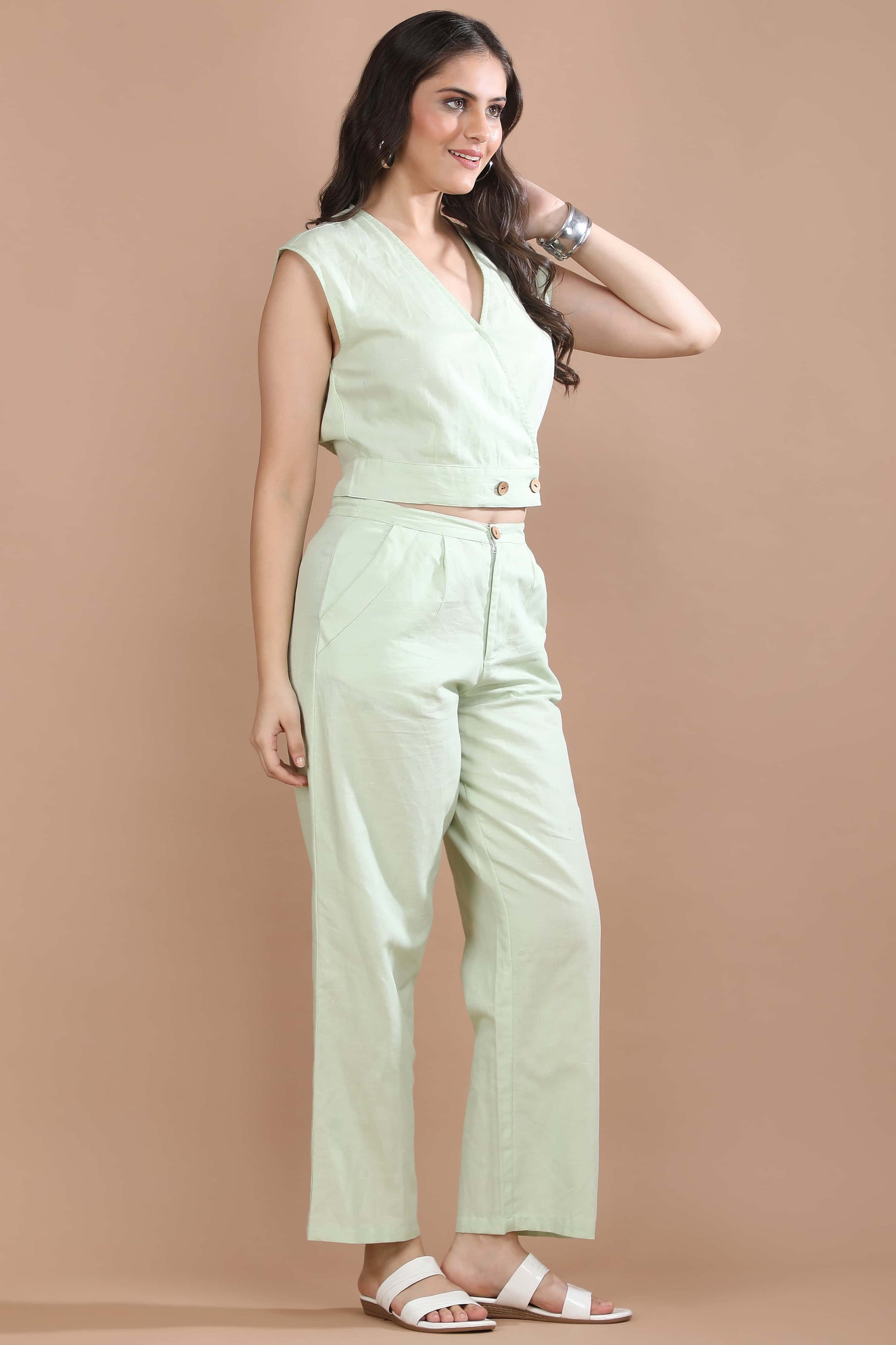 Three-quarter view of the Celadon Story co-ord set by Guilt & Class highlighting the wrap-style top and clean tailored silhouette