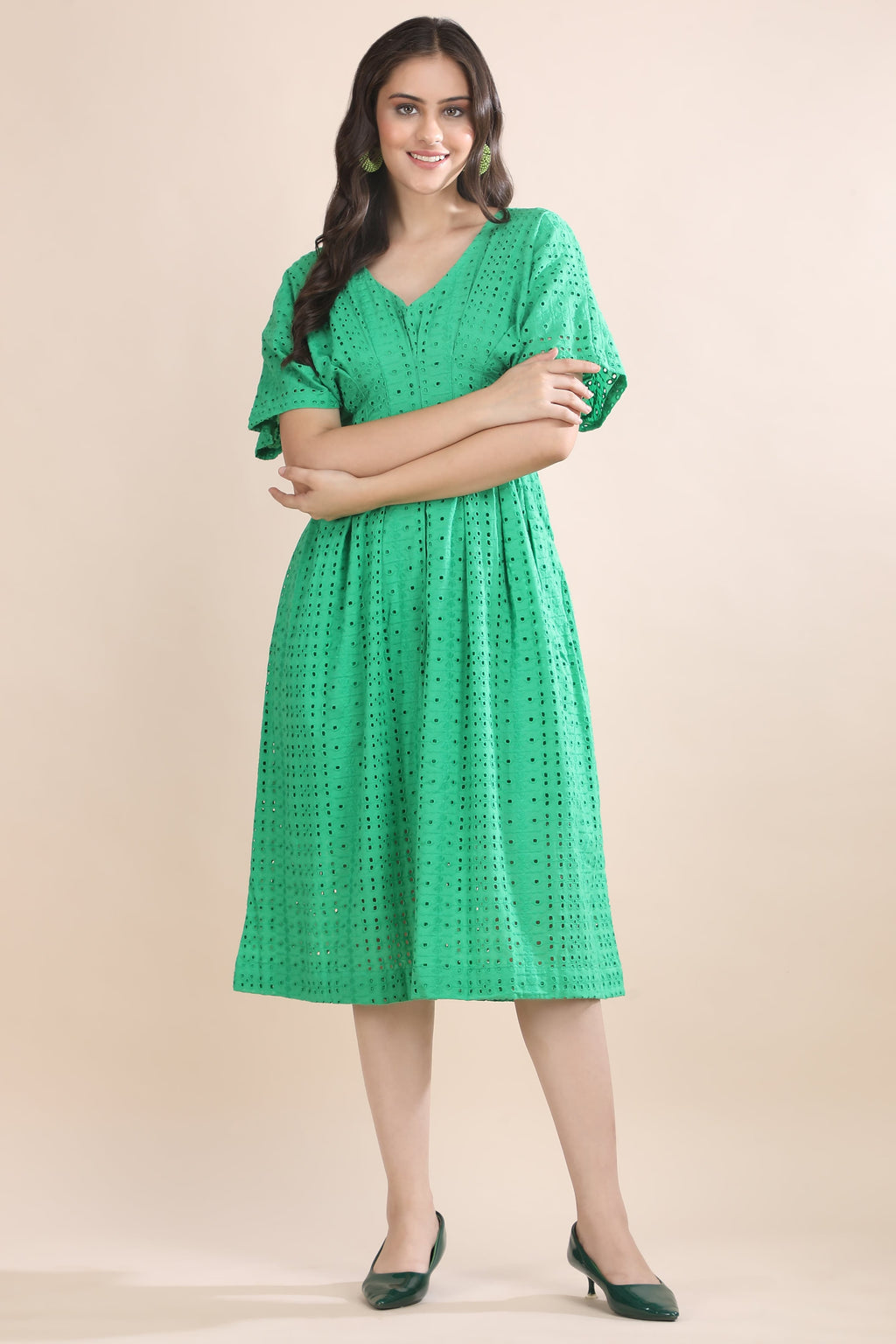 Front view of the premium green schiffli cotton dress featuring a flattering V-neck and elegant short flutter sleeves.