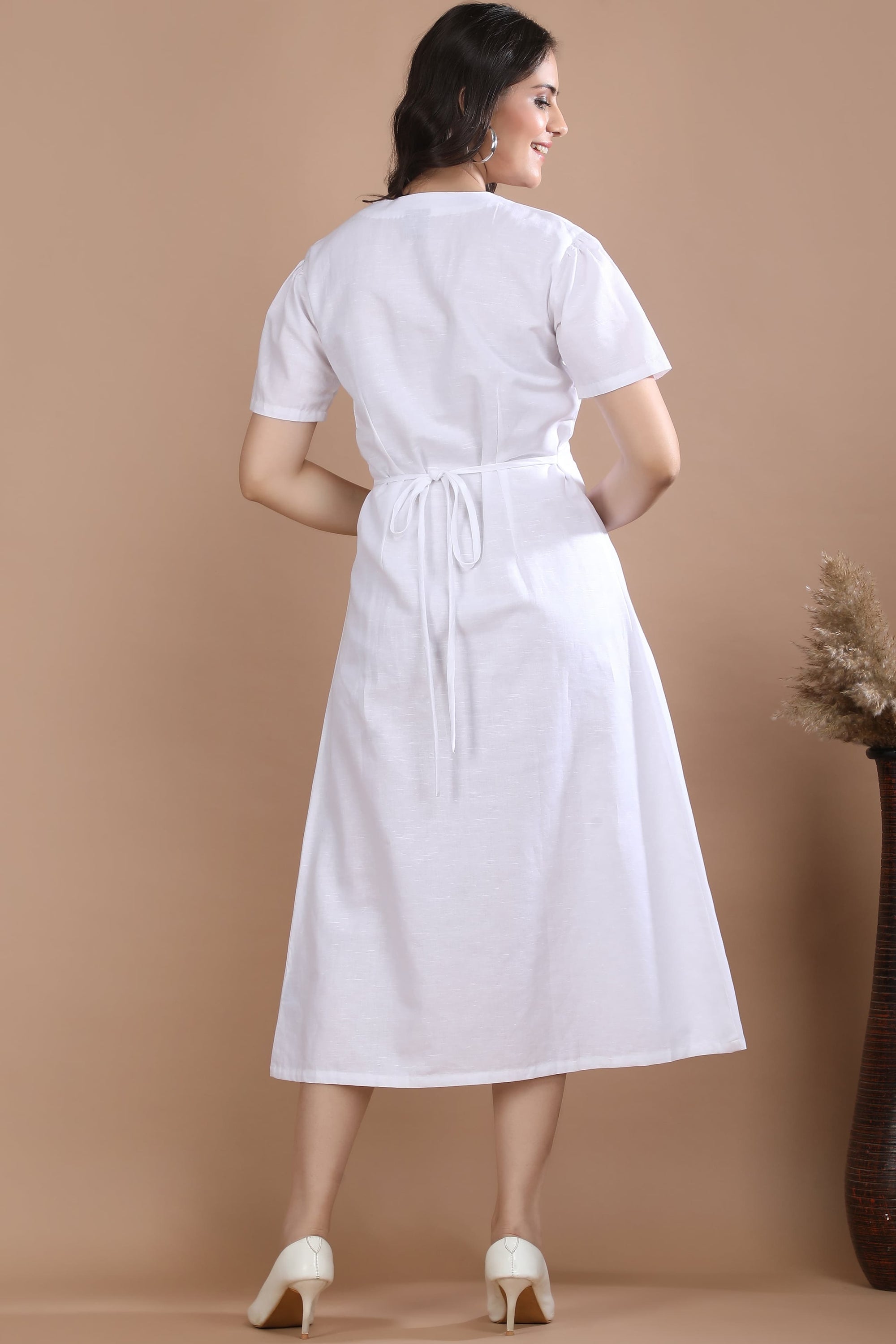 Back profile of the Ivory Wrap Midi Dress by Guilt & Class, showcasing the flattering midi length and relaxed silhouette.