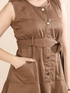 Close-up detail of the Mocha Mood dress showing the breathable fabric, structured button-down front, and elegant tie-waist belt.
