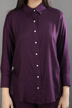 Close-up detail of the rich mulberry fabric, structured collar, and elegant pearl button closures on the premium co-ord set.