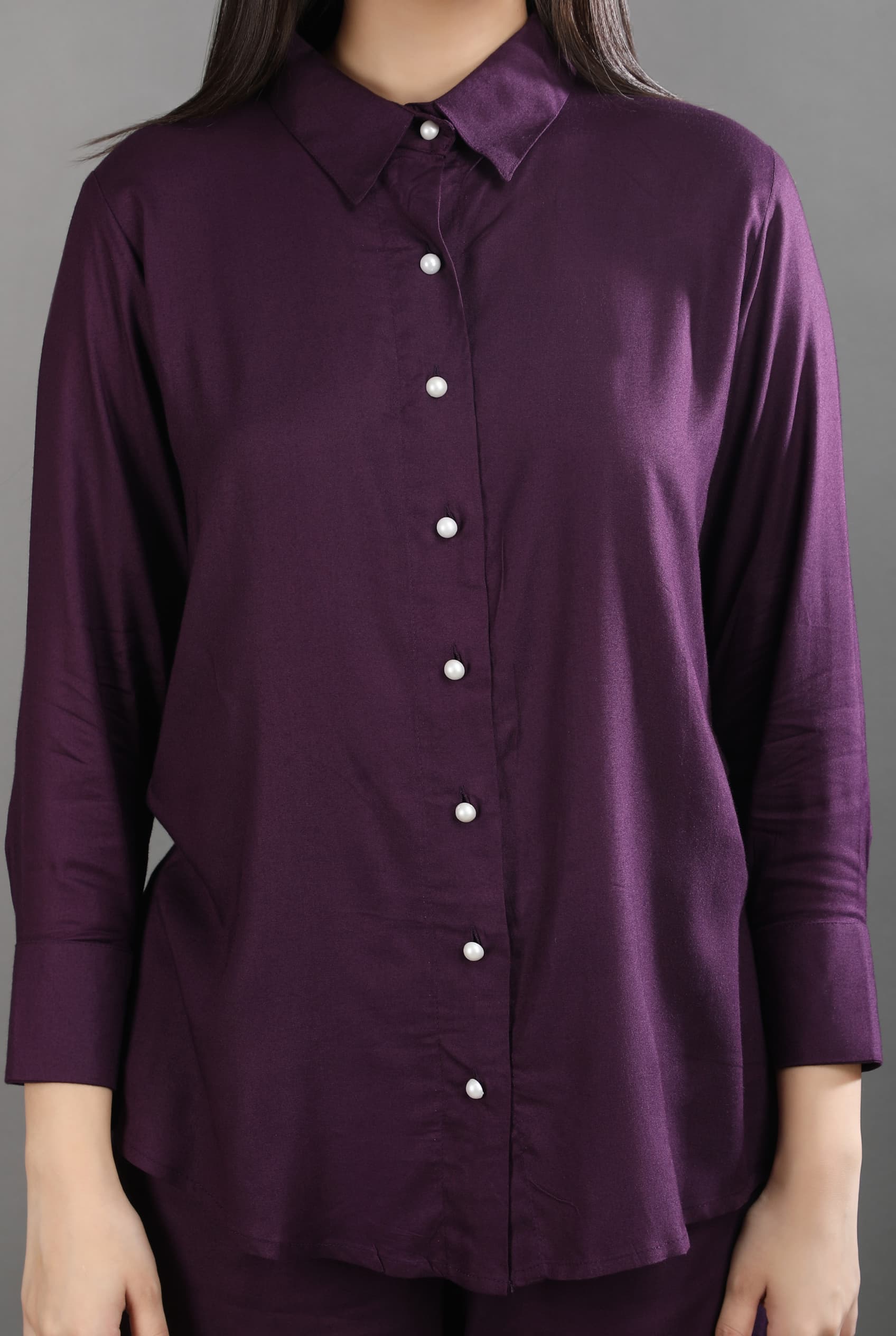 Close-up detail of the rich mulberry fabric, structured collar, and elegant pearl button closures on the premium co-ord set.