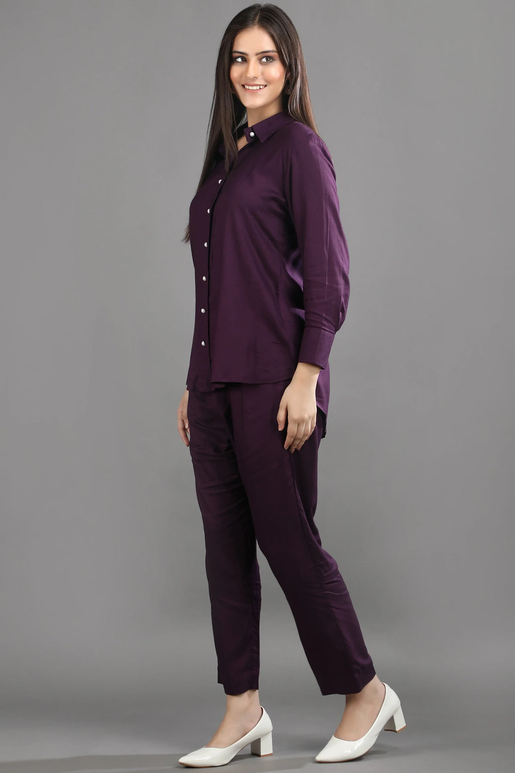 Side profile of the mulberry co-ord set, highlighting the flattering hemline of the shirt and the sleek silhouette of the matching pants.