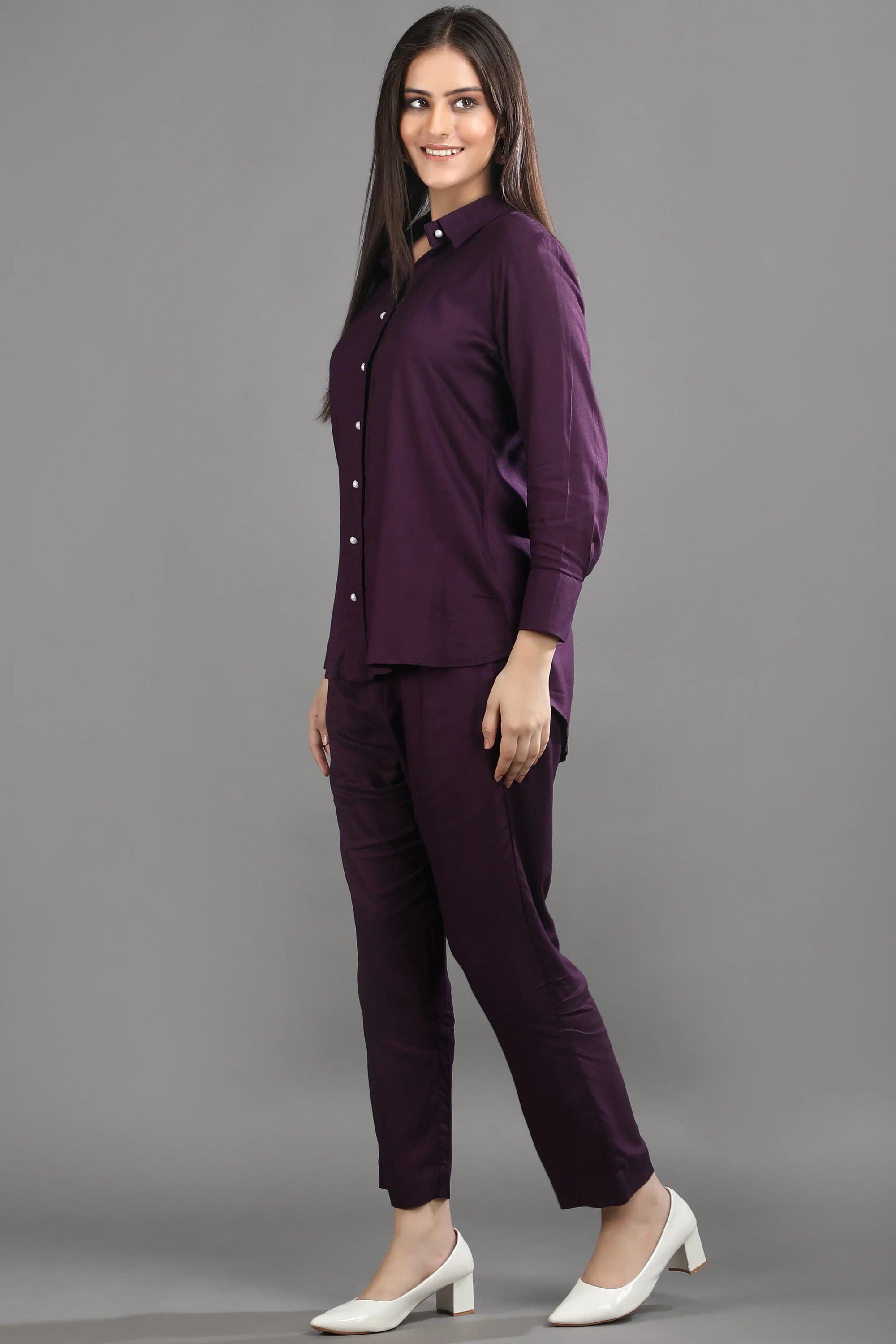 Side profile of the mulberry co-ord set, highlighting the flattering hemline of the shirt and the sleek silhouette of the matching pants.