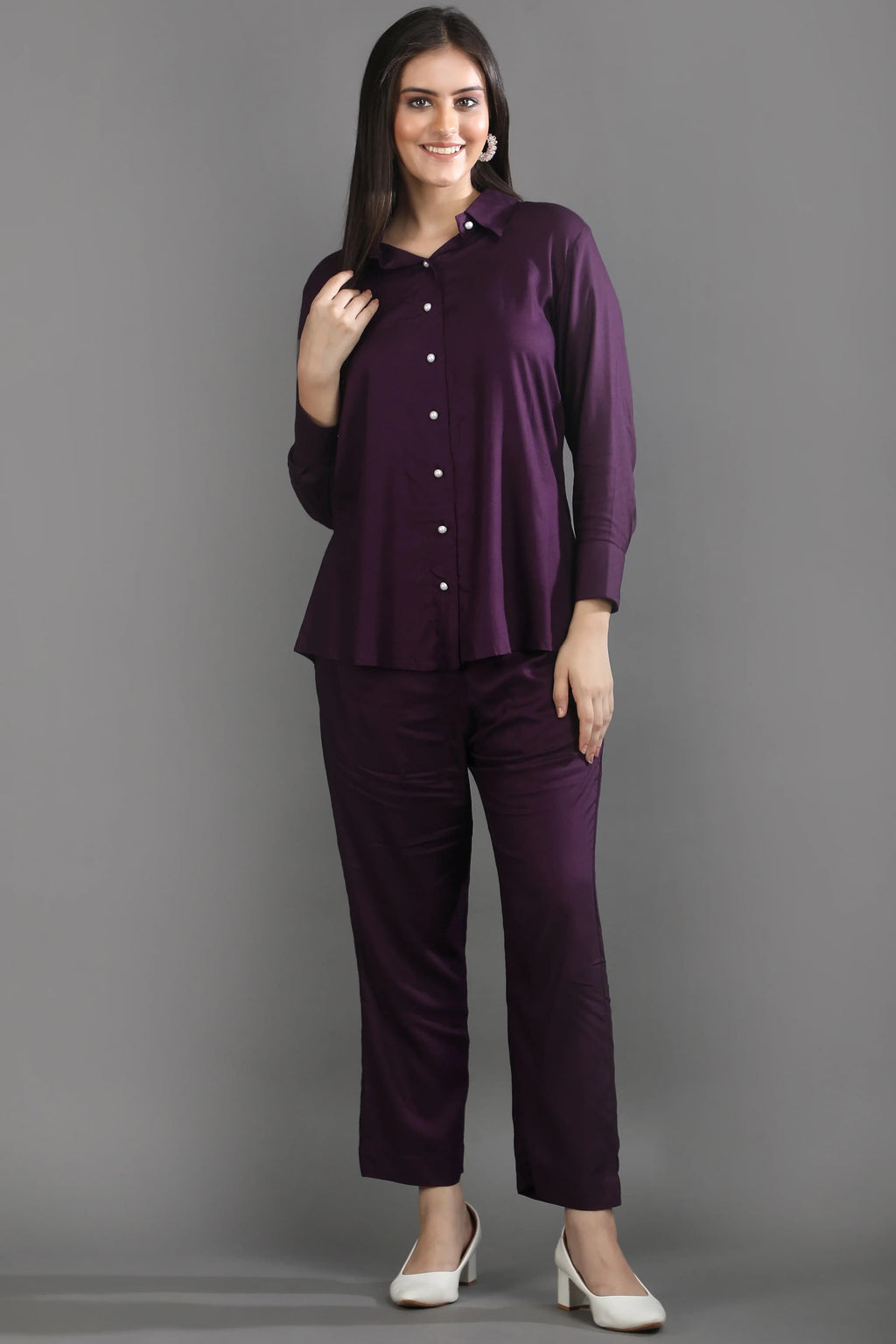 Front view of a woman wearing the premium mulberry purple long-sleeve co-ord set by Guilt & Class, styled with white heels.