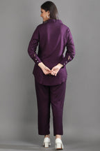 Back view of the mulberry purple matching set showing the relaxed fit of the tunic-style shirt and tailored trousers.