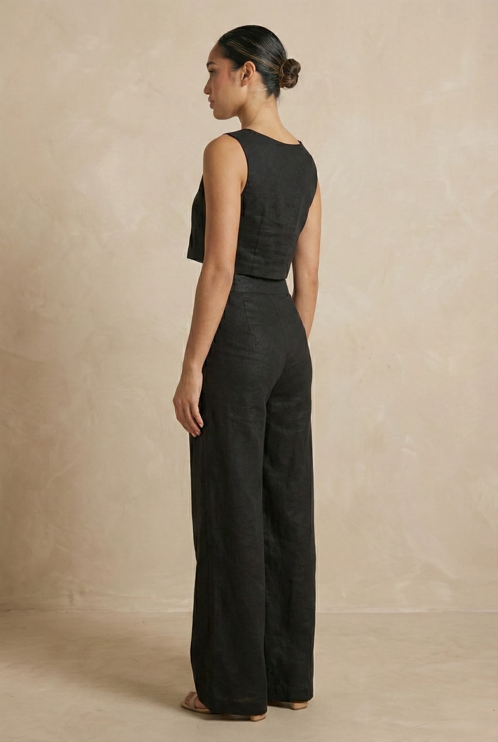 Back angled view of the Noir linen co-ord set by Guilt & Class, showcasing the tailored fit and seamless construction.
