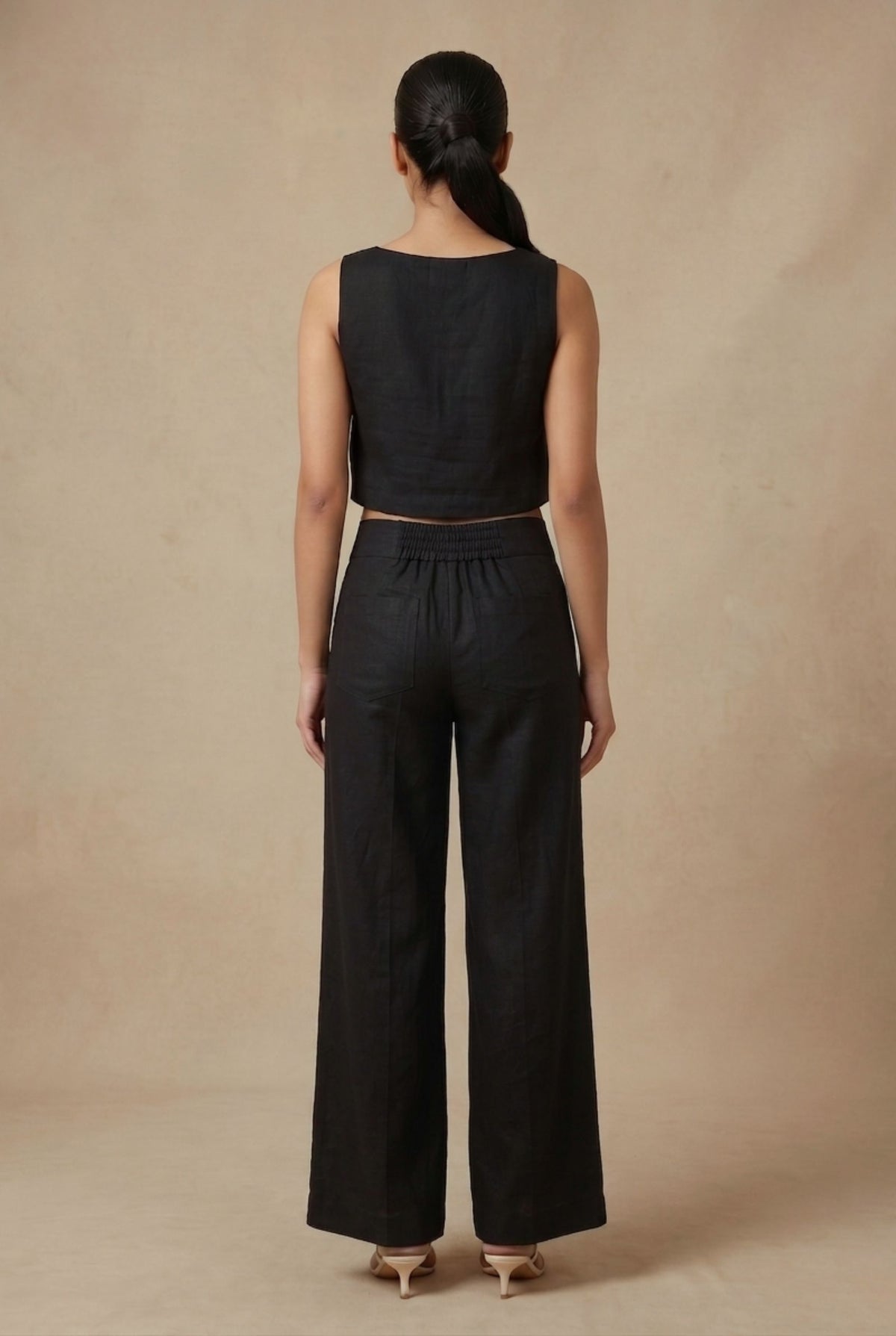 Back view of the Noir linen co-ord set by Guilt & Class, featuring a clean finish with concealed zipper closures.