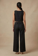 Back view of the Noir linen co-ord set by Guilt & Class, featuring a clean finish with concealed zipper closures.
