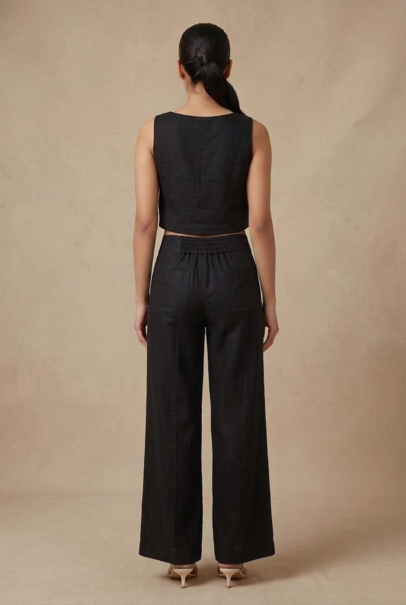 Back view of the Noir linen co-ord set by Guilt & Class, featuring a clean finish with concealed zipper closures.