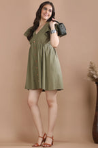 A woman modeling the versatile olive A-line dress by Guilt & Class, perfect for premium daytime styling and casual luxury looks.