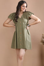 Full-length shot of a woman confidently posing in the premium olive green flutter sleeve westernwear dress by Guilt & Class.