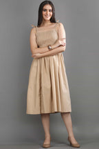 Angled view of the Second Skin midi dress by Guilt & Class, highlighting the flattering smocked fit and flowing silhouette.