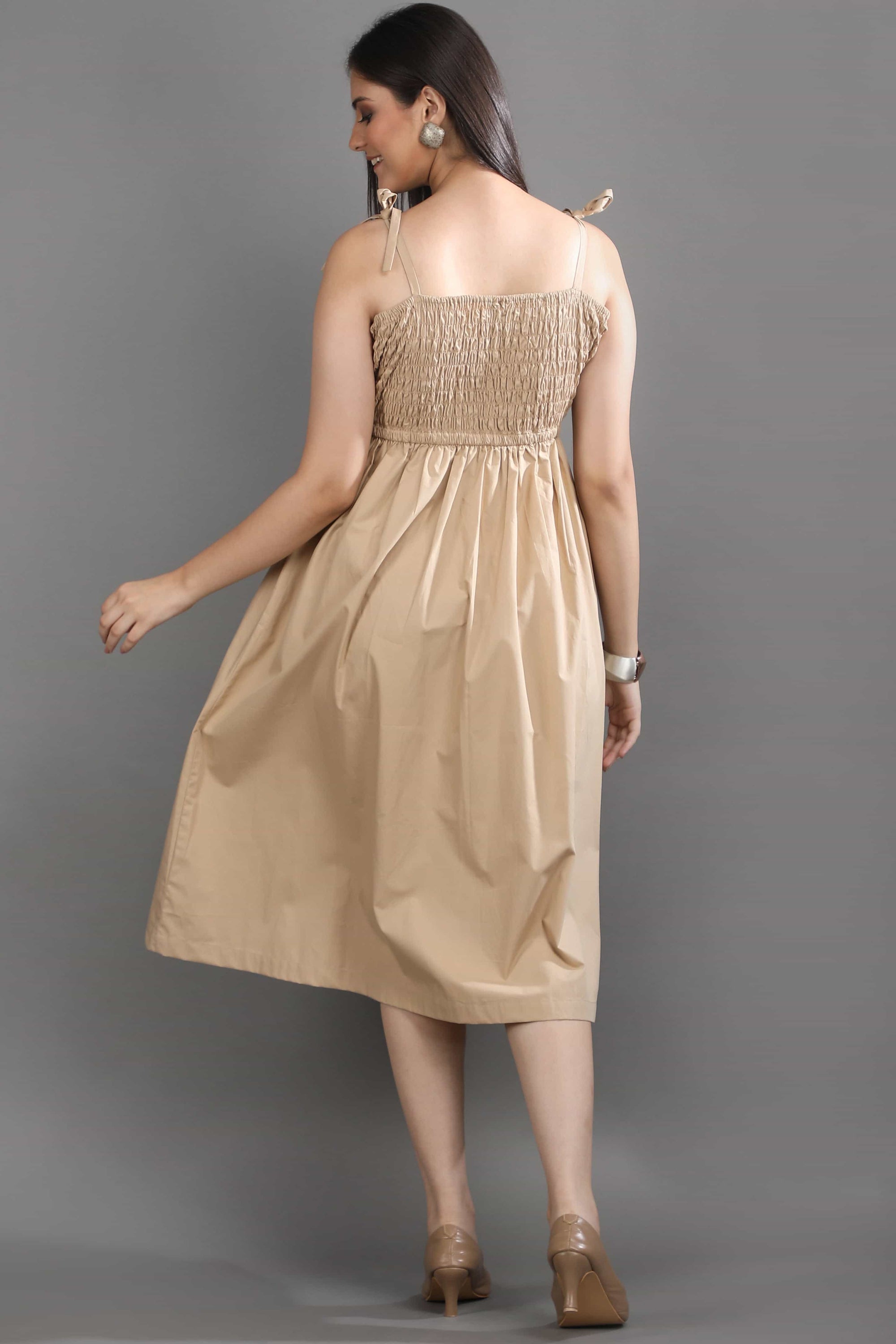 Back view of the Second Skin midi dress by Guilt & Class, featuring adjustable tie-up straps and a smocked bodice for a flexible fit.