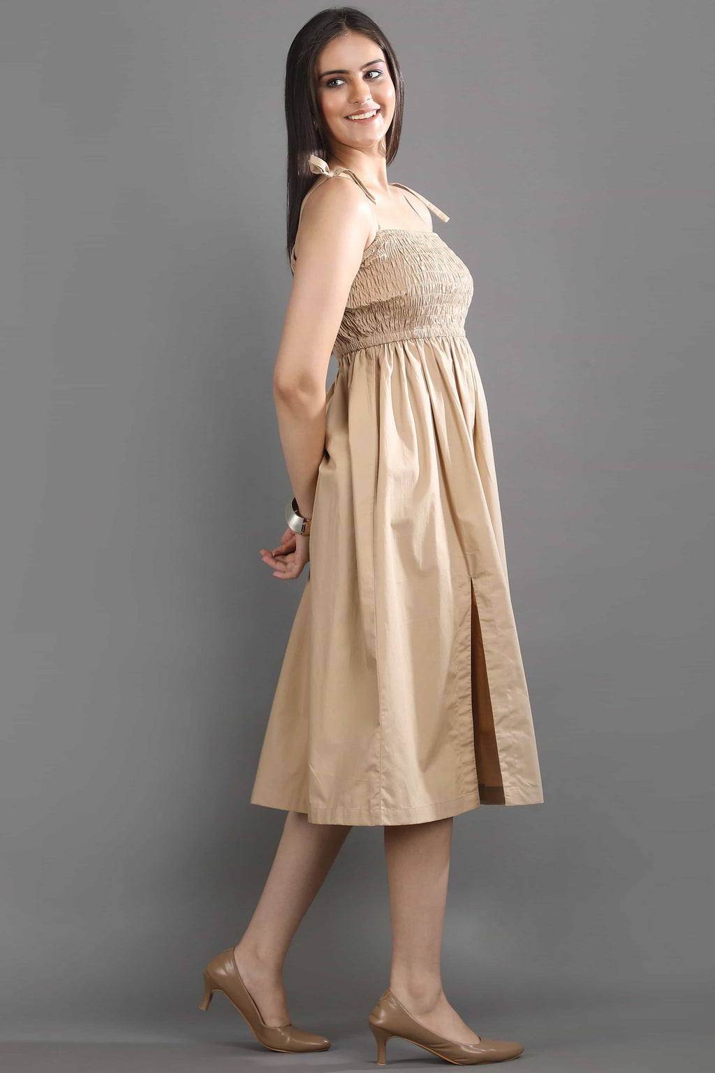 Side view of the Second Skin midi dress by Guilt & Class, showcasing the flowy silhouette and side slit for ease of movement.