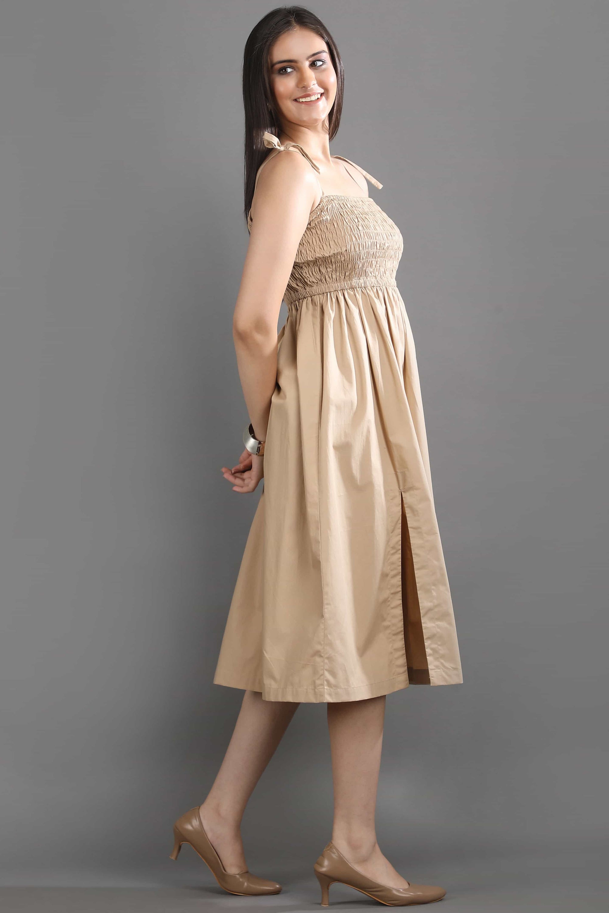 Side view of the Second Skin midi dress by Guilt & Class, showcasing the flowy silhouette and side slit for ease of movement.