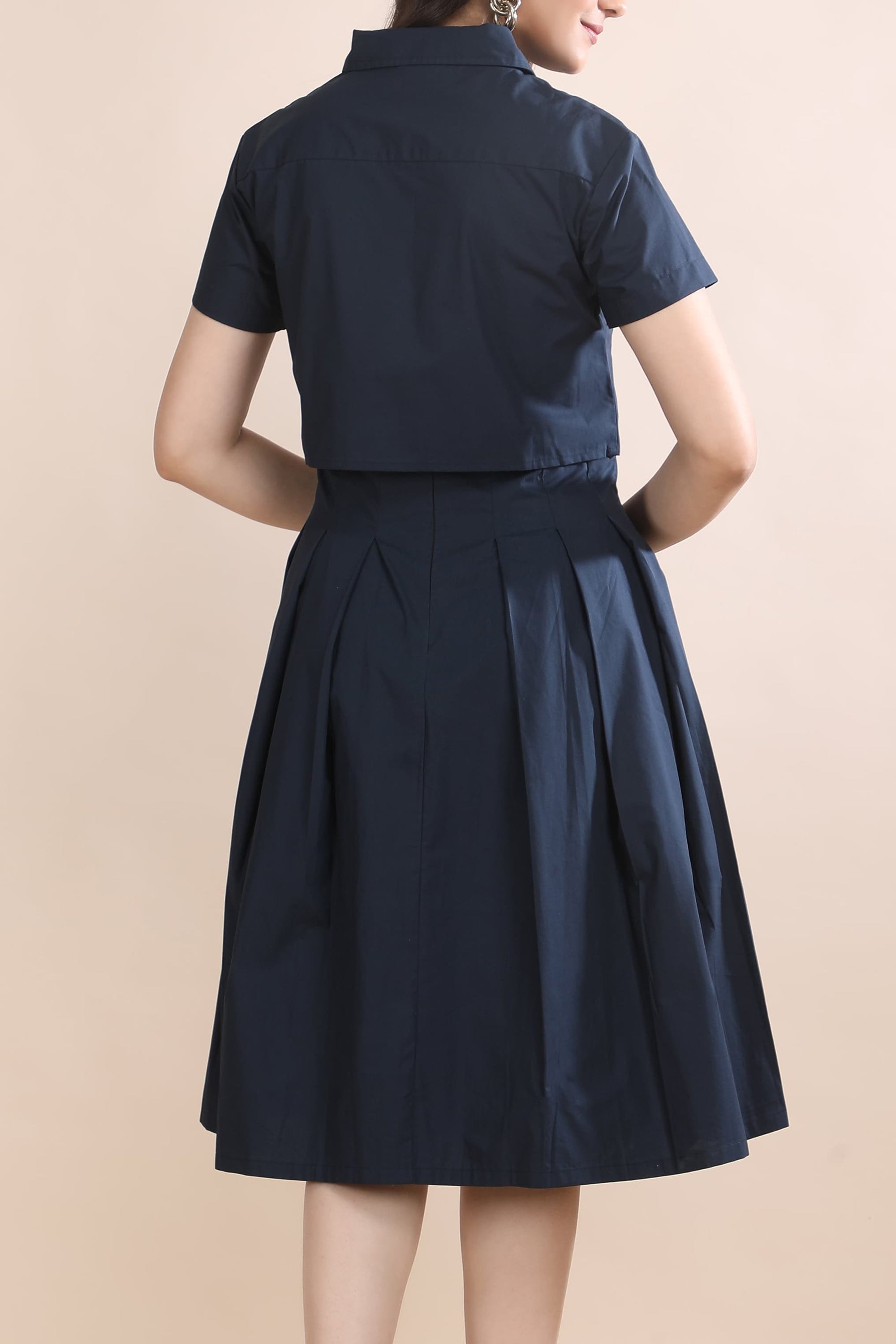 Close-up back view of the Shape in Blue co-ord set by Guilt & Class, highlighting the layered jacket and dress construction in structured cotton.