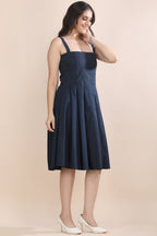 Angled view of the Shape in Blue dress and jacket set by Guilt & Class, highlighting the structured silhouette and layered design.