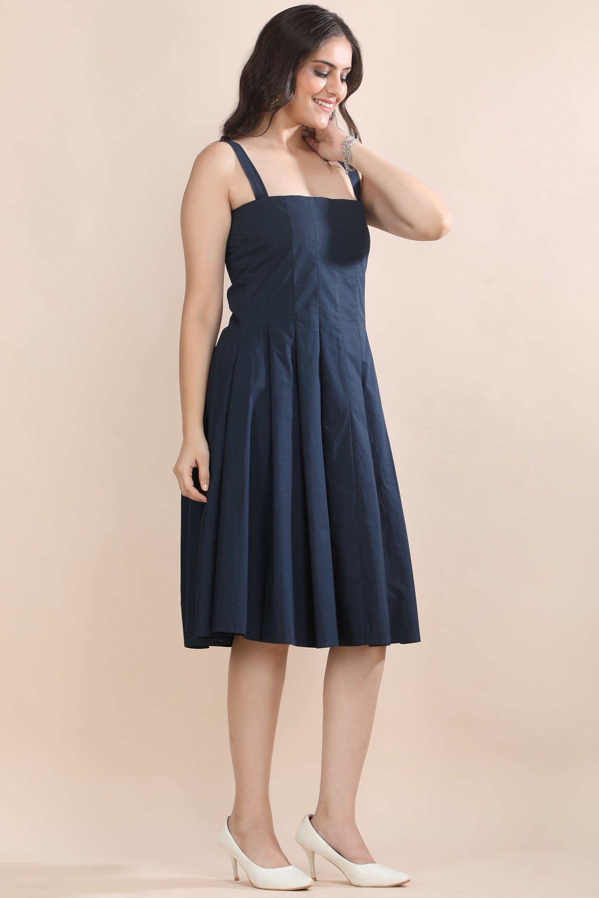 Angled view of the Shape in Blue dress and jacket set by Guilt & Class, highlighting the structured silhouette and layered design.